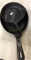 Two cast-iron frying pan's, one sizzler fryer,