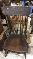 Antique pressed back wood rocking chair with some