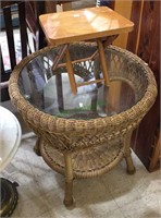 Round wicker patio table with a glass top with a