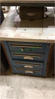Four drawer blue metal storage cabinet with a