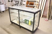 Glass front display case on metal feet