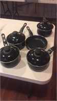 Nine piece black pots with lids and pan