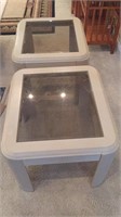 Two white tables with glass tops