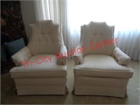 2 white upholstered swivel rocker chairs