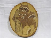 Raccoons on wood plaque