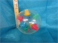 Early plastic ball learning toy; has a small ball