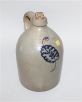 Stoneware jug with cobalt blue design of a plant