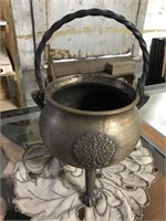 OLD HEAVY FOOTED BRASS POT W/ EMBLEM ON FRONT