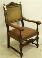 ANTIQUE LEATHER ARMCHAIR WITH CARVED CREST