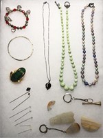 Carved stones, beaded necklaces, pins