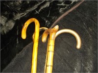 4 WOOD CARVED HANDLED CANES ONE TIP SILVER?