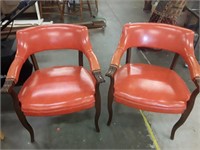 2 orange vintage barrell back chairs