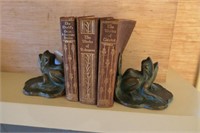 Pair of frog bookends with leather bound books