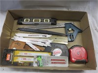 Flat with tape measures, level, saw blades
