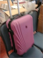 Pink hard suitcase with wheels