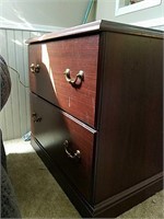 2 mahogany colored two-drawer file cabinets