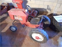 Red unmarked pedal tractor