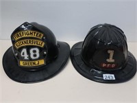 Two American black fire helmets