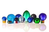 Assorted coloured glass paperweights and spheres