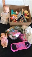 Group of baby dolls and toys