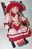 Porcelain Doll In Rocking Chair