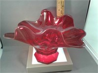 Red heavy glass bowl Rim is elongated and fluted