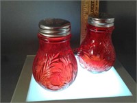 Set of red salt and pepper shakers inverted