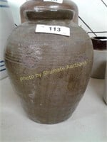 Rounded clay container with in incised marks