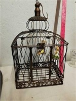 Metal bird cage with swinging rabbits