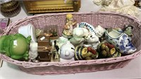 Pink wicker basket with Porcelain figures, cats,