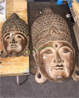 Two wood carved wall hanging heads they look to