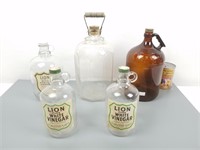 5 bouteilles en verre dont Lion
