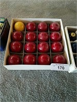 Box of 15 solid red balls and cue ball