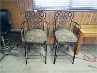 Pair of wrought iron bar stools with arms good