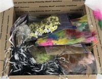 A box of feathers and other decorative items