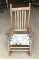 Old wood rocker with plastic woven seat