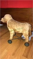Antique stuffed dog on wheels, 16 inches tall