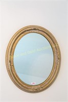 Oval framed wall mirror