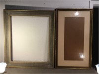 Two large frames. One with glasses and a mat, 22“