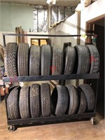 16 slightly used tires 14 to 15 inch w/ rack