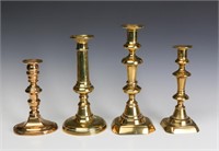 FOUR BRASS PUSH-UP CANDLESTICKS CIRCA 1800