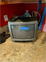 Small Tv With Remote On Kitchen Counter