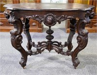 Heavily carved parlor table