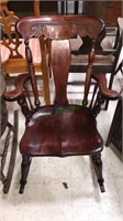 Cherry rocking chair with a fancy carved back