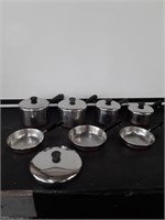 7 Revere Ware pans and extra lid for larger pan.