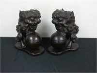 Pair of carved wood foo dogs having hinged sphere