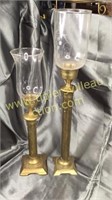 Pair of brass candle stands with globes tallest