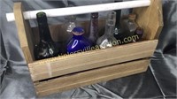 Wooden tote with old bottles