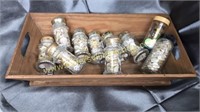 Wooden tray with buttons in glass containers