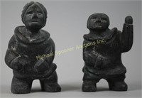 TWO INUIT STONE CARVINGS OF A MAN AND A WOMAN